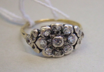 Appraisal: A diamond set cluster ring designed as a flowerhead mounted