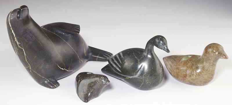 Appraisal: Four Inuit Animal Carvingsthe first of a reclining seal green