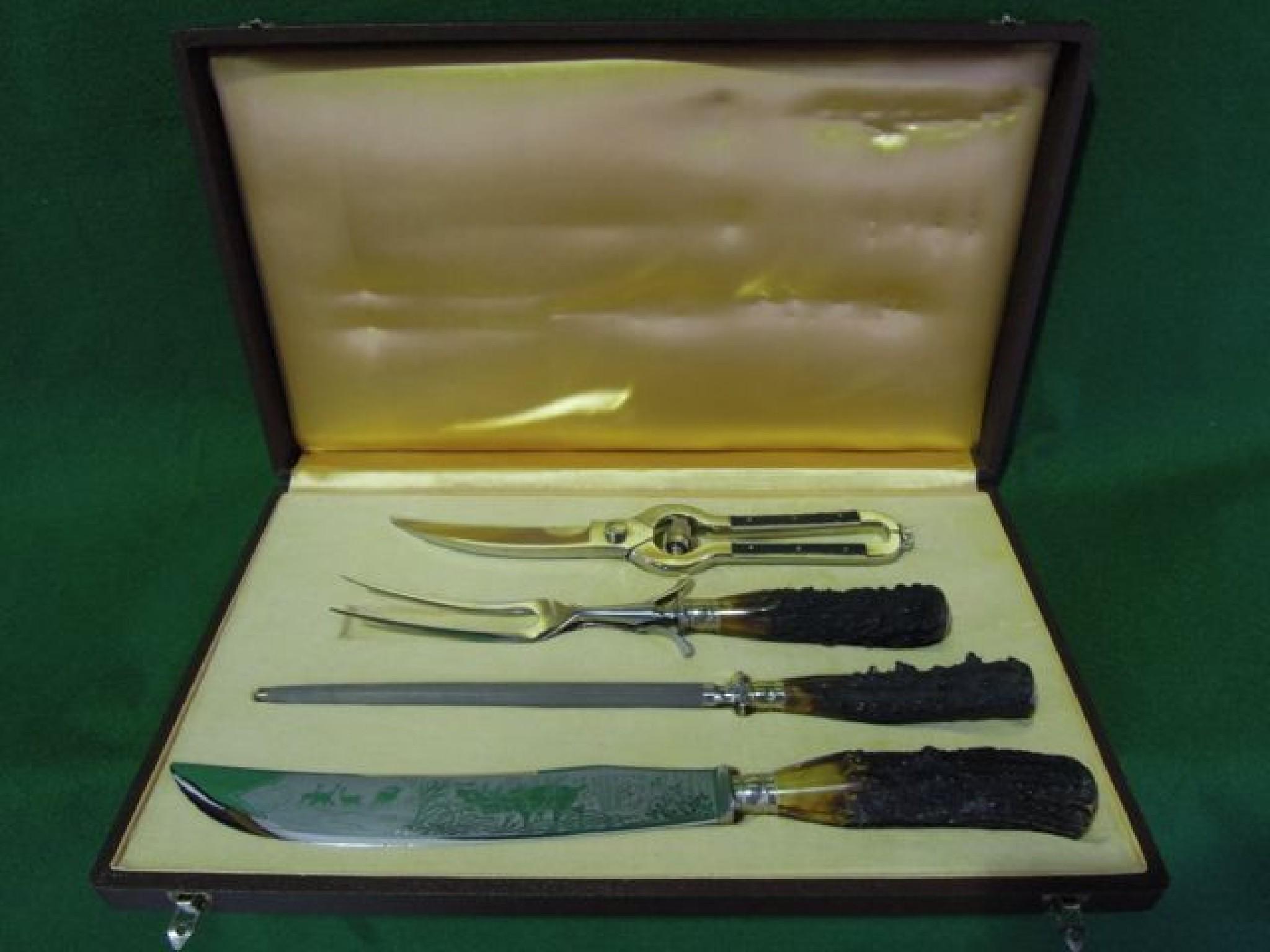 Appraisal: A boxed horn handled carving set comprising carving knife and