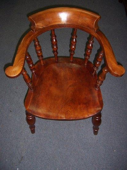 Appraisal: An elbow chair with turned galleried back over a shaped