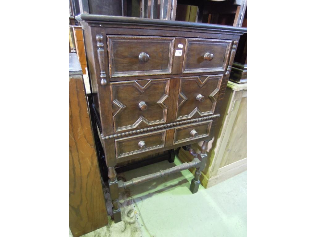 Appraisal: An oak Jacobean revival chest fitted with an arrangement of