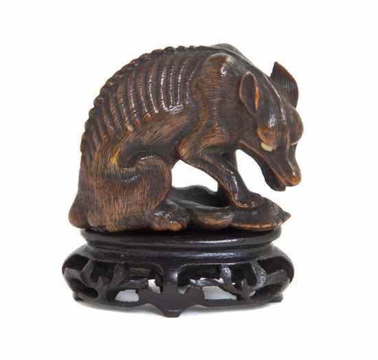 Appraisal: A Carved Wood Netsuke of a Wolf the emaciated animal