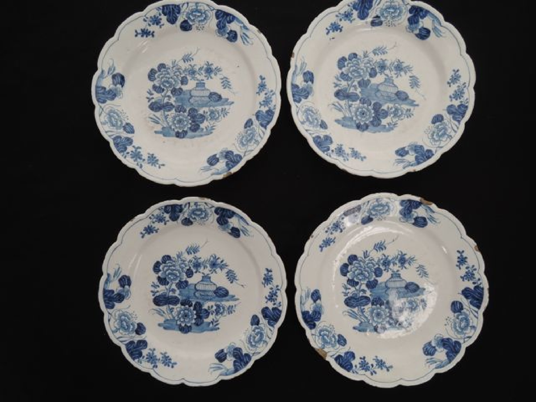 Appraisal: Four late th century tin glazed plates with hand painted