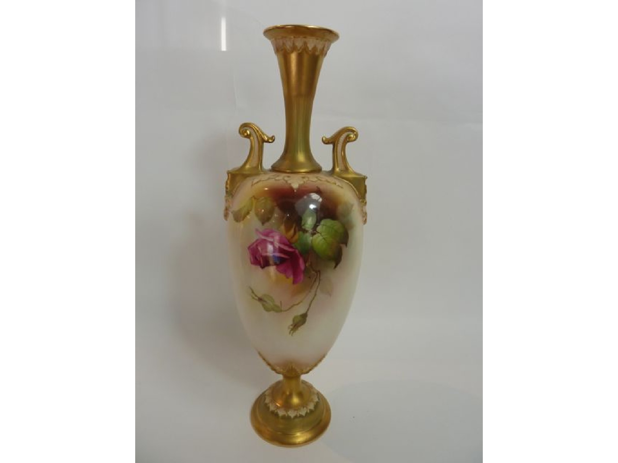 Appraisal: A tall Royal Worcester two handled vase of slender form