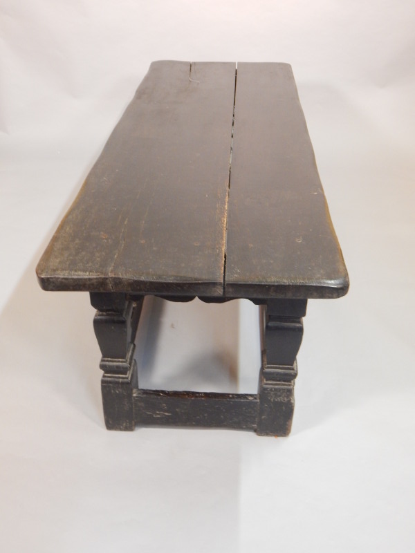 Appraisal: An ebonised oak low refectory type table with two plank