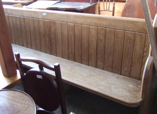 Appraisal: A pine church pew with ledge back cm long