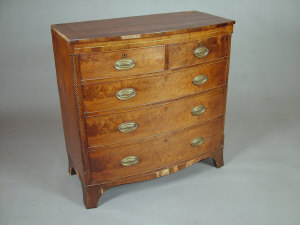 Appraisal: A George IV mahogany bowfront chest of two short and