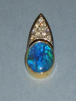 Appraisal: A BLACK OPAL AND DIAMOND PENDANT the oval cabochon collet