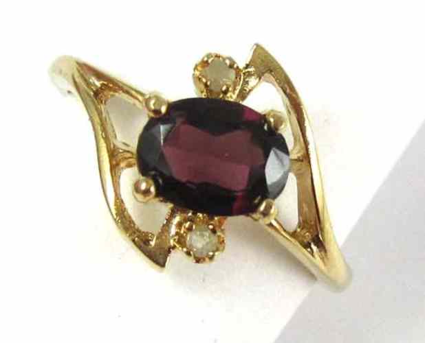 Appraisal: GARNET DIAMOND AND FOURTEEN KARAT GOLD RING set with two