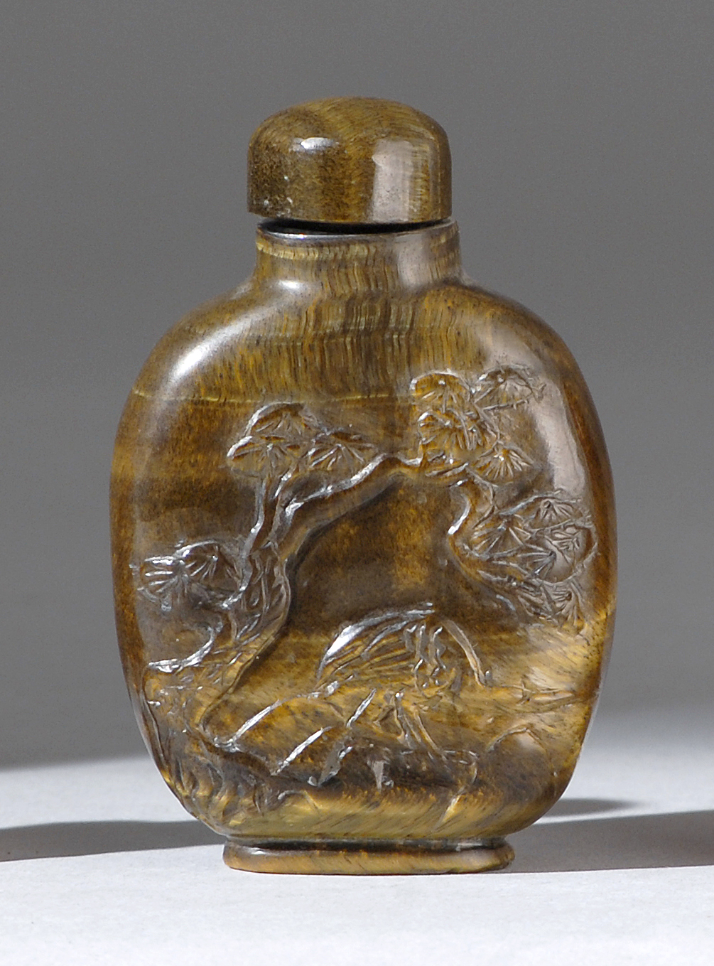 Appraisal: TIGER'S-EYE SNUFF BOTTLE In flattened ovoid form with figural landscape