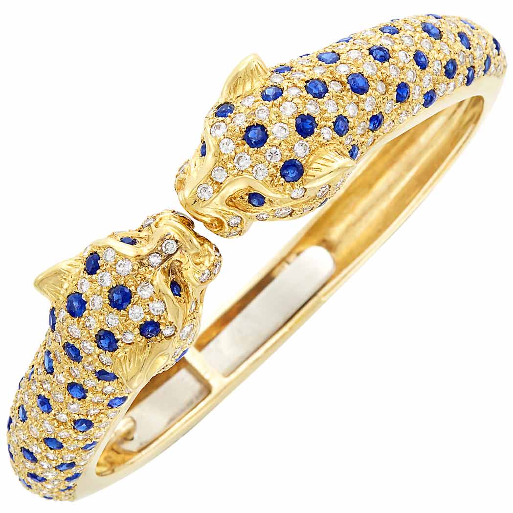 Appraisal: Gold Diamond and Sapphire Panther Head Bangle Bracelet Round diamonds