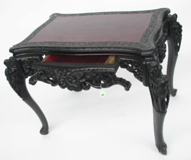 Appraisal: An Oriental mahogany carved console table with drawer figural carvings