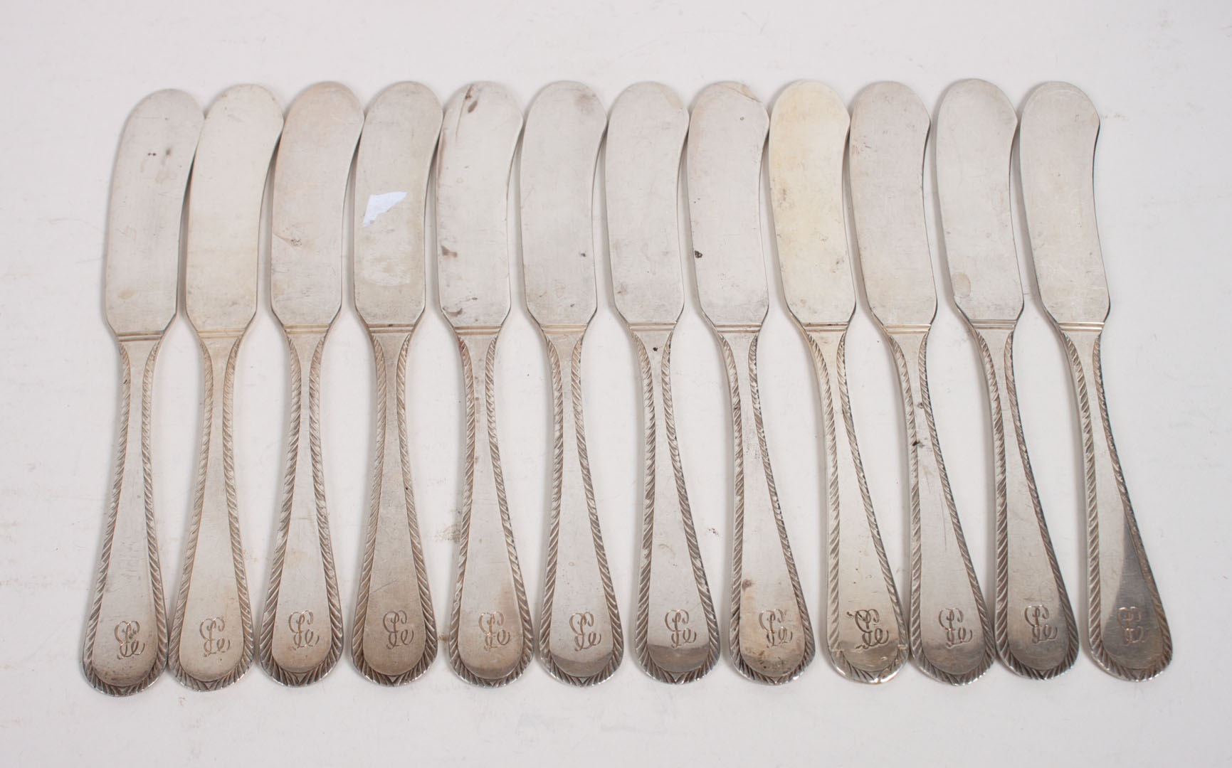 Appraisal: Twelve Tuttle sterling silver butter spreaders mid- th century in