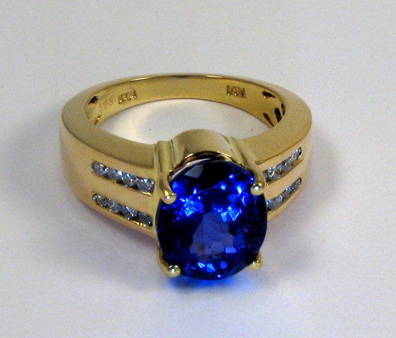 Appraisal: TANZANITE AND DIAMOND RING k yellow gold and centering an