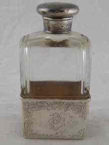 Appraisal: A cut glass brandy flask with silver cup and mount