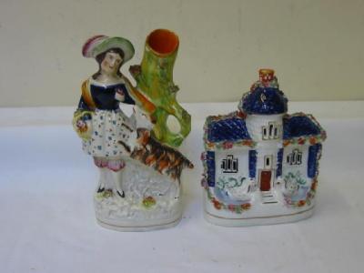 Appraisal: A STAFFORDSHIRE POTTERY SPILL VASE modelled as a lady holding