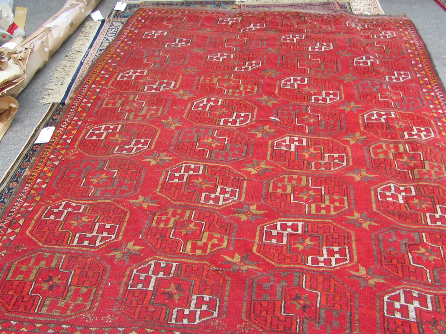 Appraisal: An Afghan carpet the madder field with four columns of