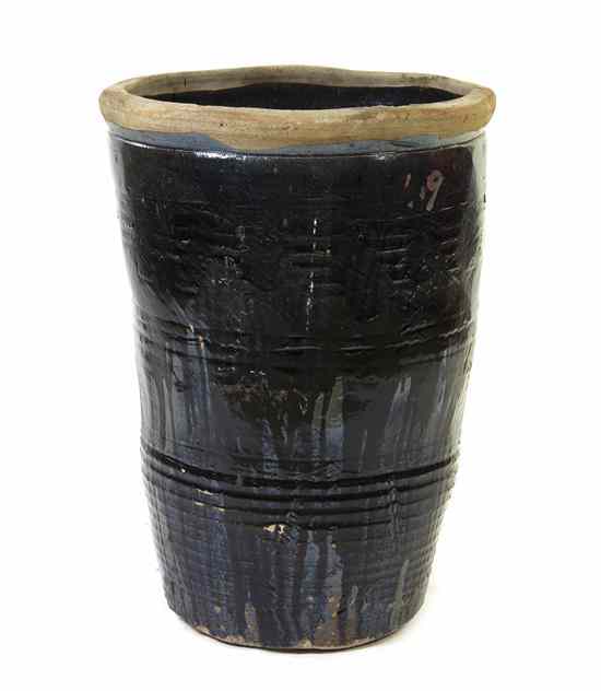 Appraisal: A Chinese Glazed Pottery Jar of tapering cylindrical form with