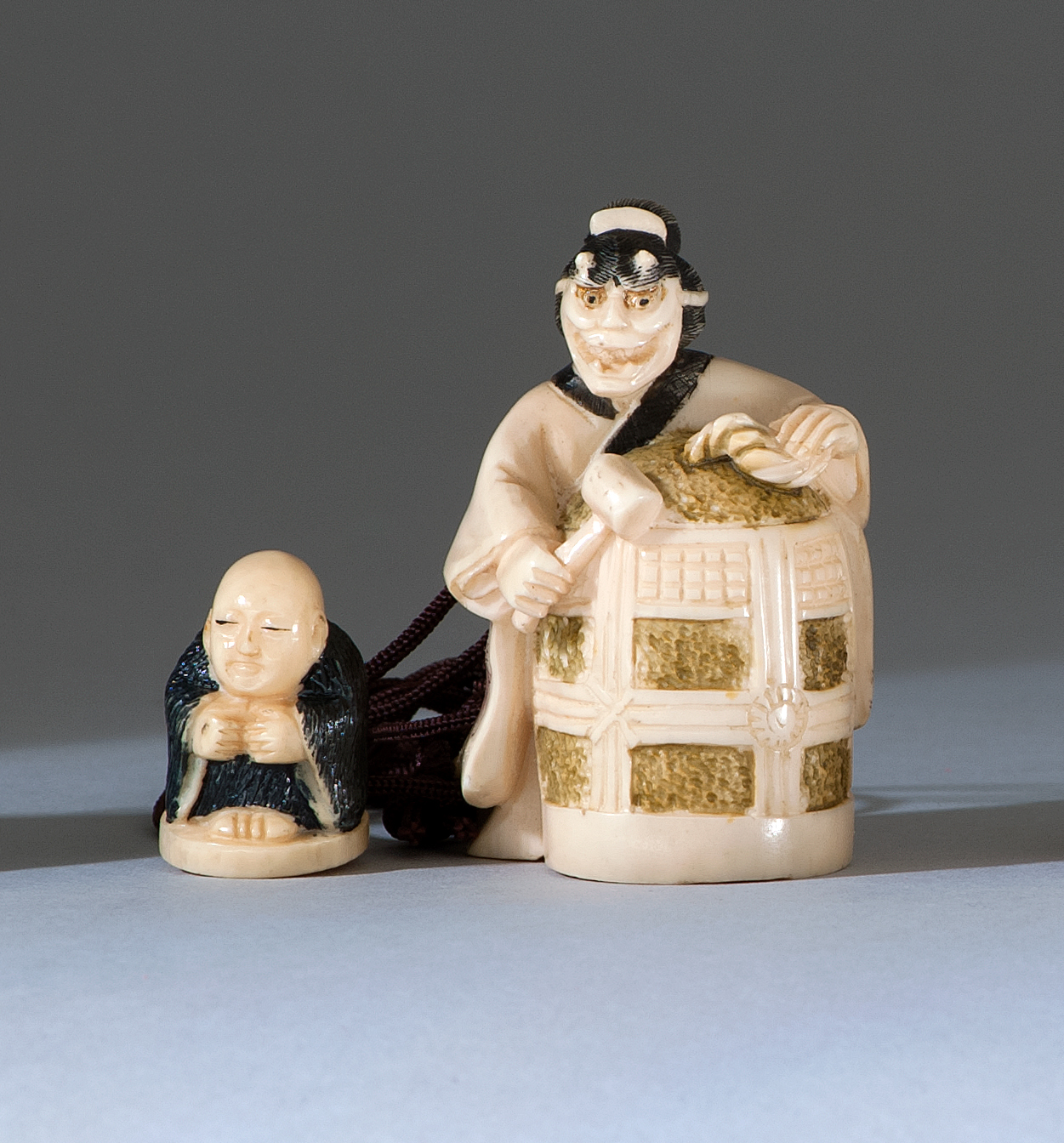 Appraisal: POLYCHROME IVORY NETSUKE Depicting Kiyohime with the bell of Dojoji