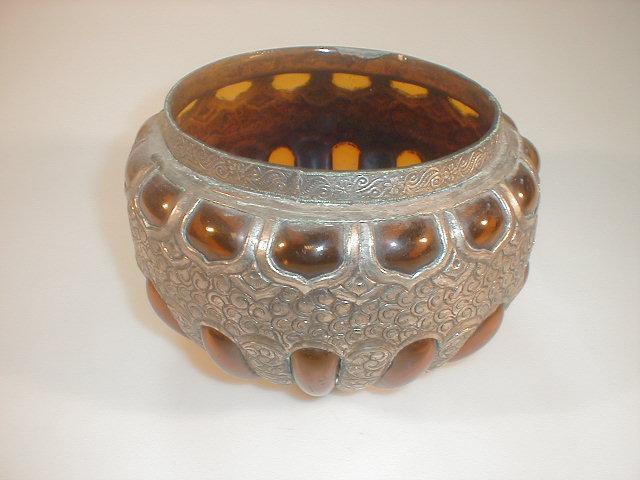 Appraisal: An amber glass lobed circular bowl with white metal overlay