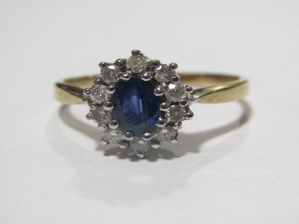 Appraisal: Nine carat gold Ceylon sapphire and diamond cluster ring