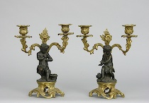 Appraisal: Pair of French Bronze Figurative Candelabra Whimsical bronze putti mounted