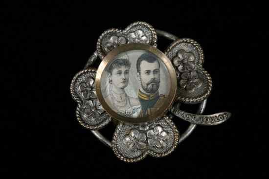 Appraisal: RUSSIAN SILVERED METAL COMMEMORATIVE BROOCH Circa Floral-form centering marriage portrait