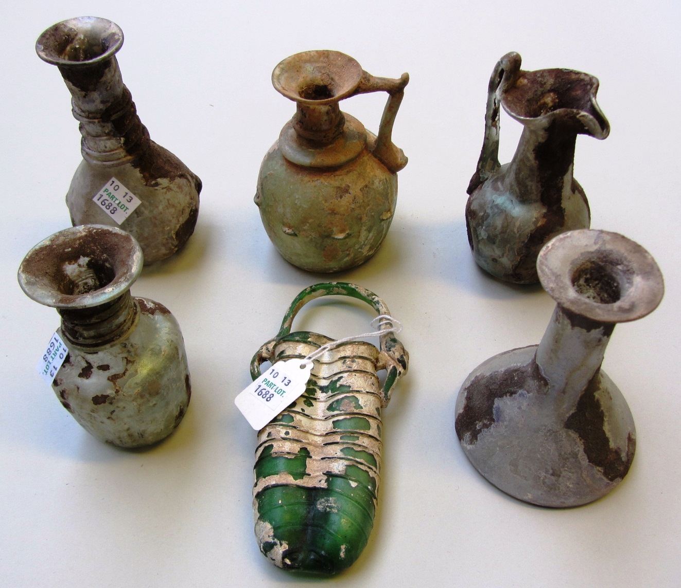 Appraisal: Six Roman glass vessels including a green double balsamarium circa