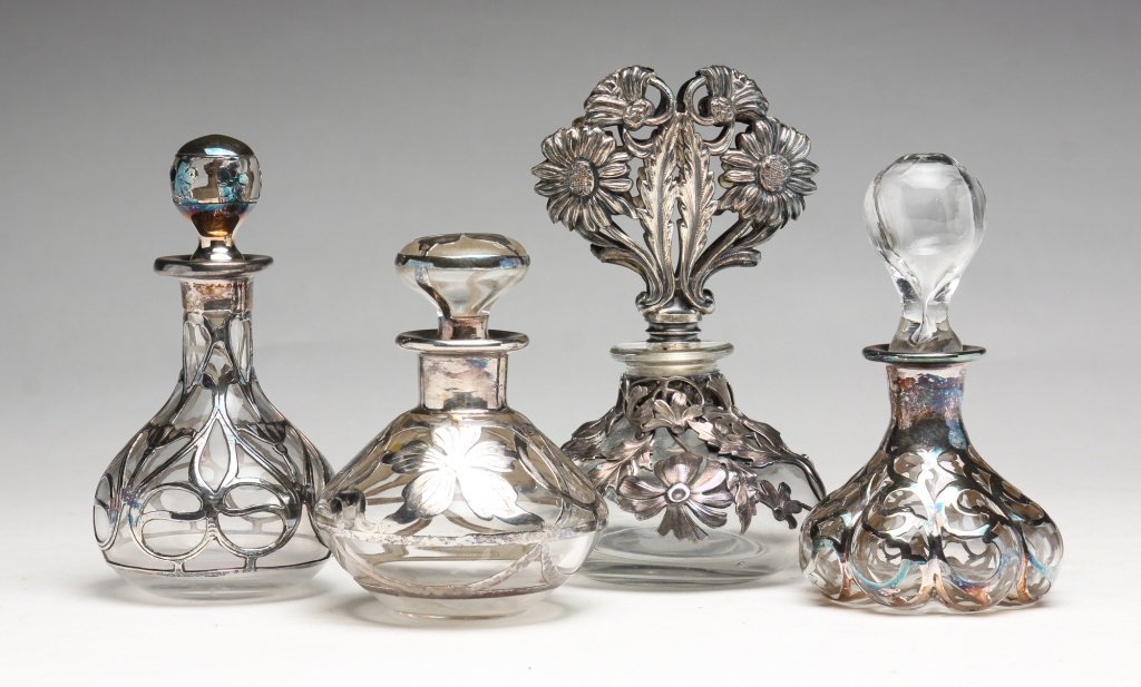 Appraisal: FOUR SILVER OVERLAY PERFUMES European th century Glear glass perfume