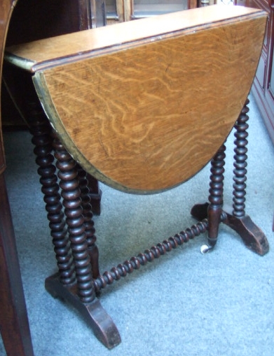 Appraisal: A Victorian oak small oval Sutherland table with bobbin turned