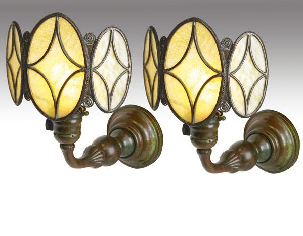 Appraisal: TIFFANY STUDIOS Pair of early bronze wall sconces with three-panel