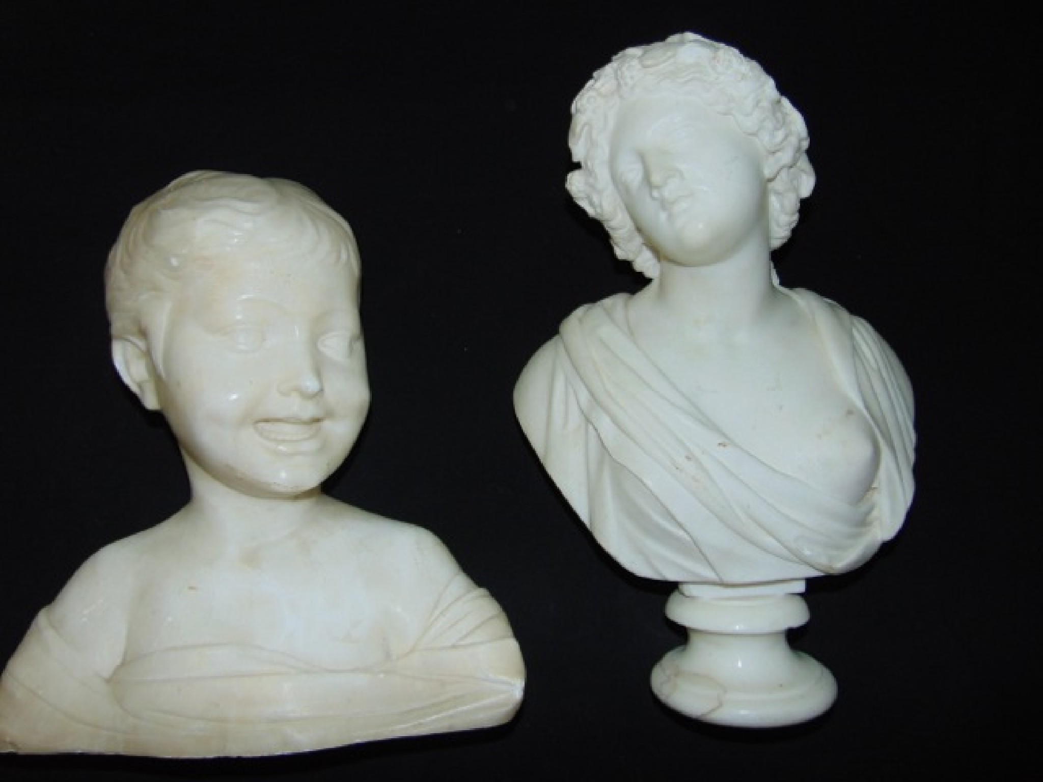 Appraisal: A carved white alabaster bust of a young boy with