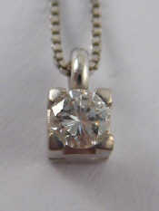 Appraisal: A white metal tests carat gold diamond solitaire pendant the