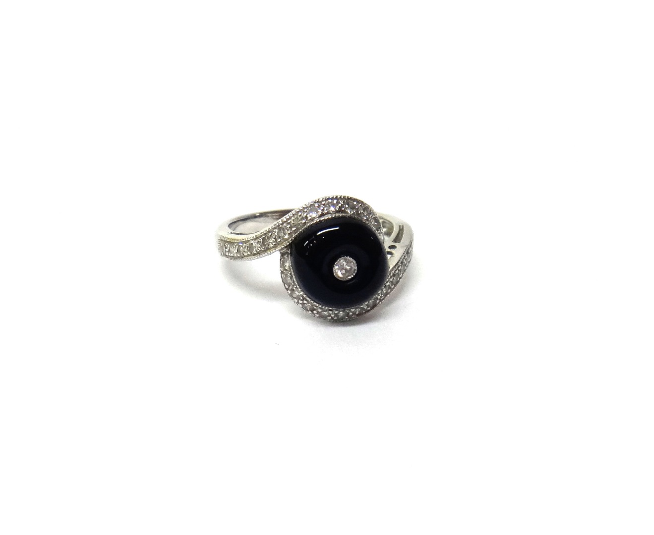 Appraisal: A white gold diamond and black onyx set ring mounted