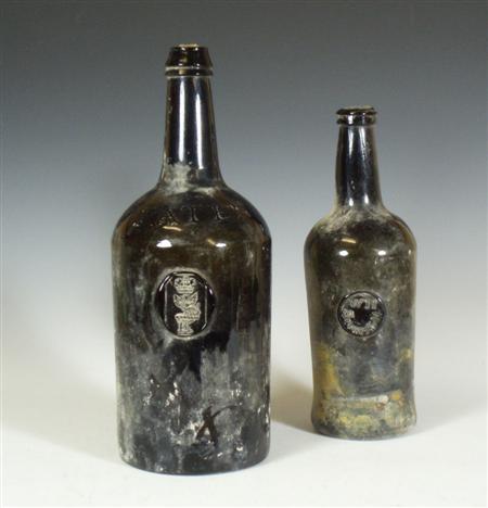 Appraisal: Two th century dark green glass seal wine bottles comprising