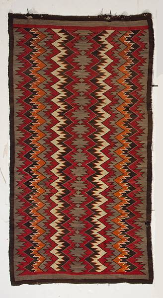 Appraisal: A Navajo Red Mesa rug Aligning conjoined diamond serrates flanked