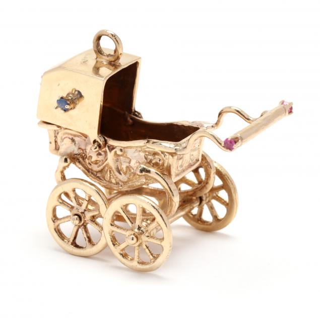 Appraisal: GOLD AND GEM-SET BABY CARRIAGE CHARM The gold baby carriage