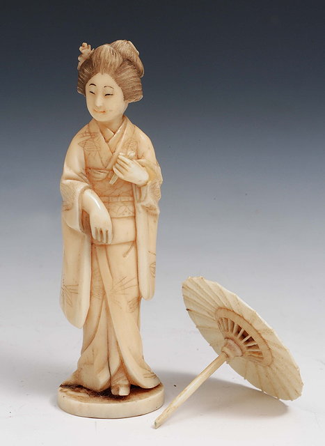 Appraisal: A small Japanese ivory Geishalate th Centurythe figure holding a