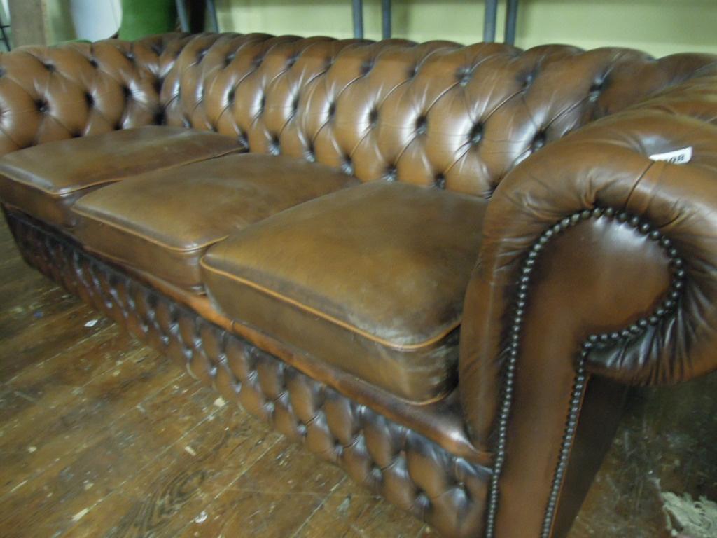 Appraisal: A modern traditional style Chesterfield three seat sofa with button