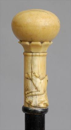 Appraisal: IVORY-HANDLED EBONIZED WOOD WALKING STICK The twist-off petal-tip banded cap