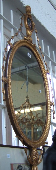 Appraisal: A th century gilt framed wall mirror with pineapple finial