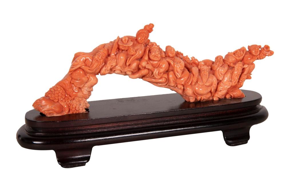 Appraisal: CHINESE CARVED CORAL GROUPresting on a fitted wood base inches