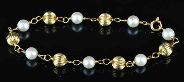 Appraisal: K Gold Pearl BraceletFashioned with k gold puff balls interspaced