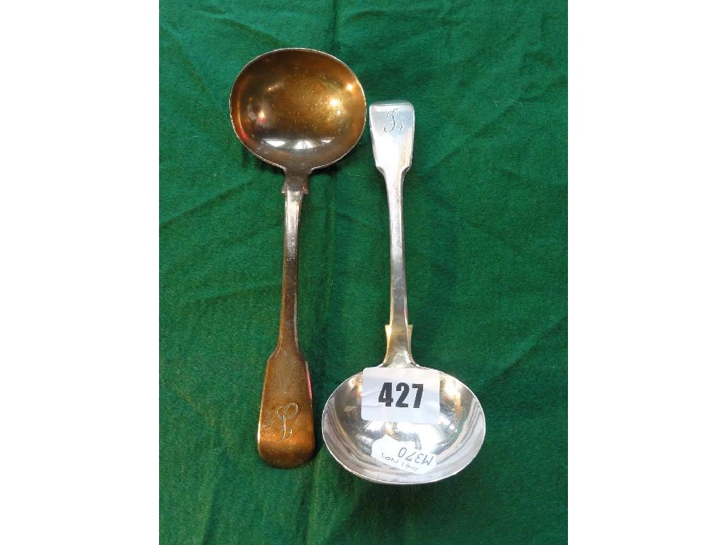 Appraisal: A pair of Victorian silver fiddle pattern sauce ladles monogrammed