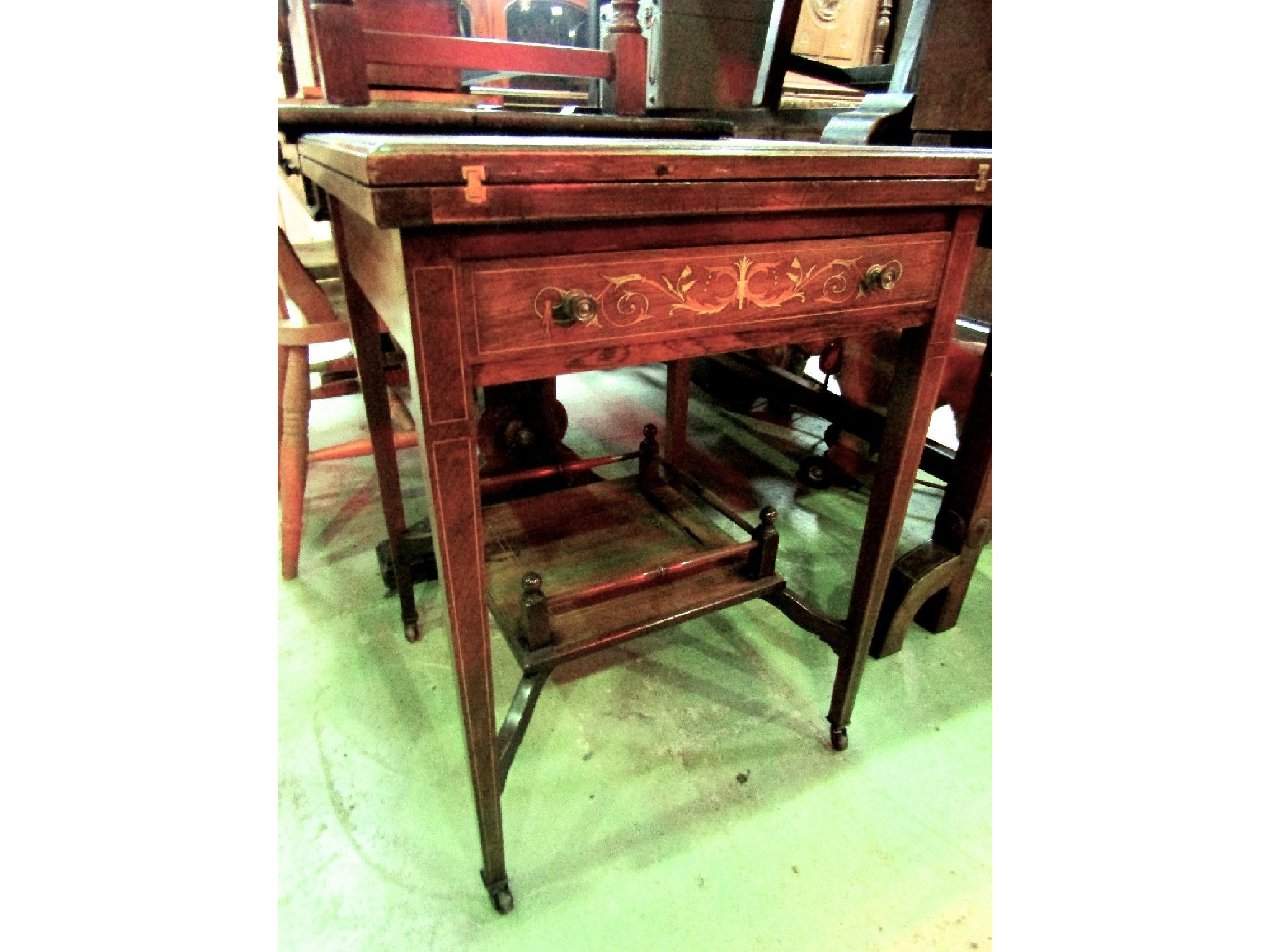 Appraisal: An inlaid Edwardian rosewood envelope card table with urn and