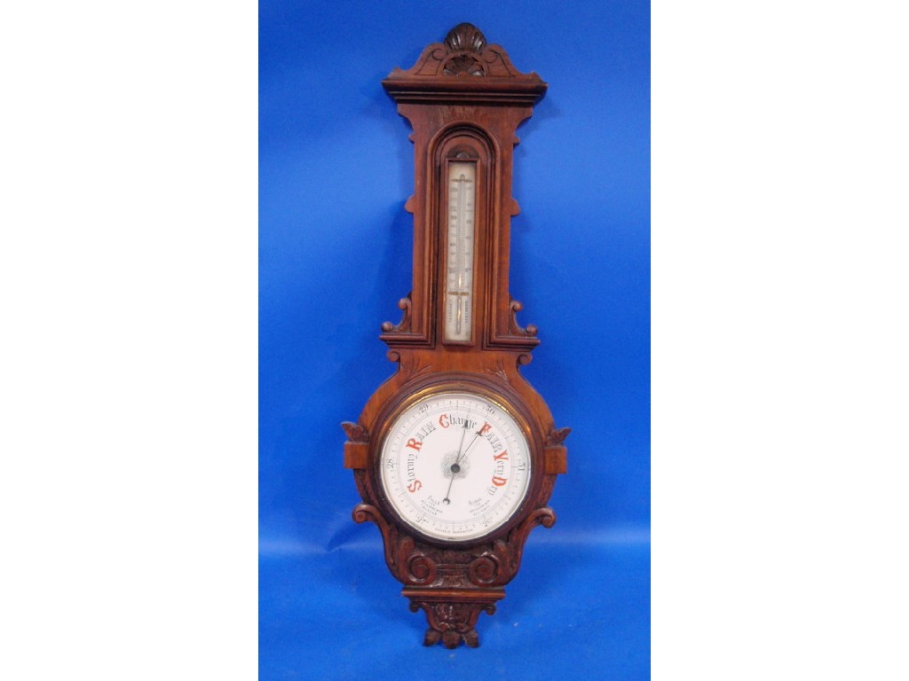 Appraisal: An Edwardian oak cased aneroid barometer cm high