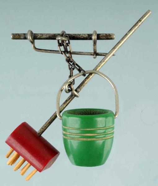 Appraisal: Bakelite Pin with Suspended Broom Bucket Condition Excellent Size -