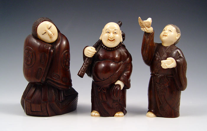 Appraisal: CHINESE CARVED IVORY WOOD FIGURES Average '' high