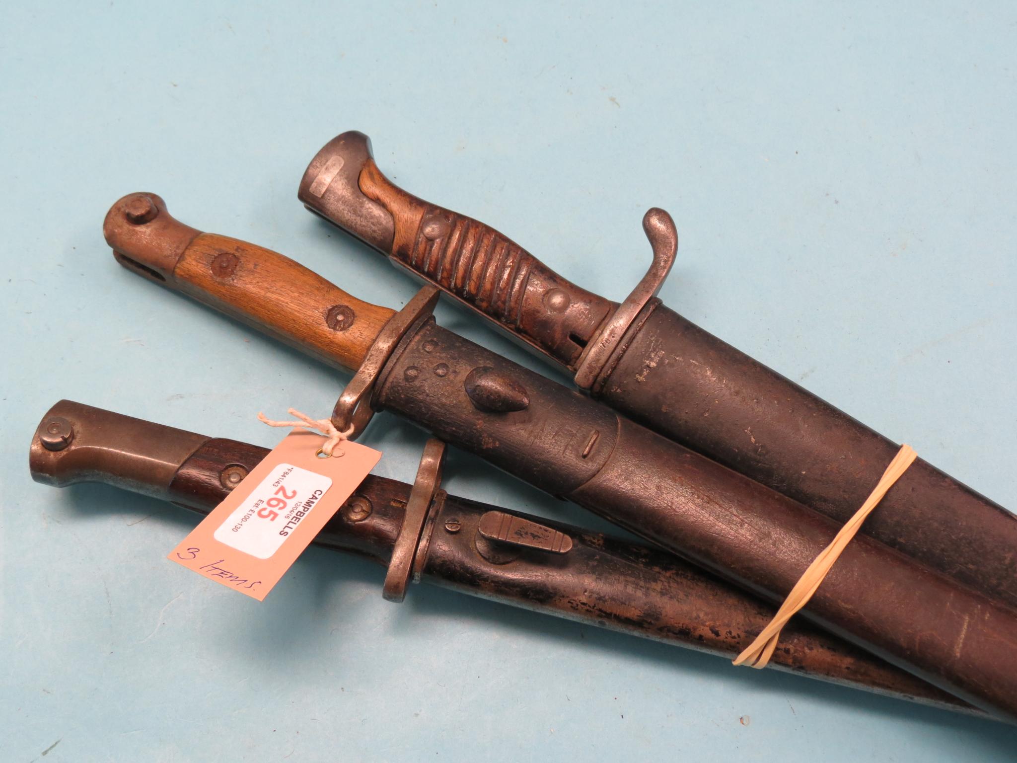 Appraisal: Three various WWI bayonets each within metal sheath Shipping arrangements