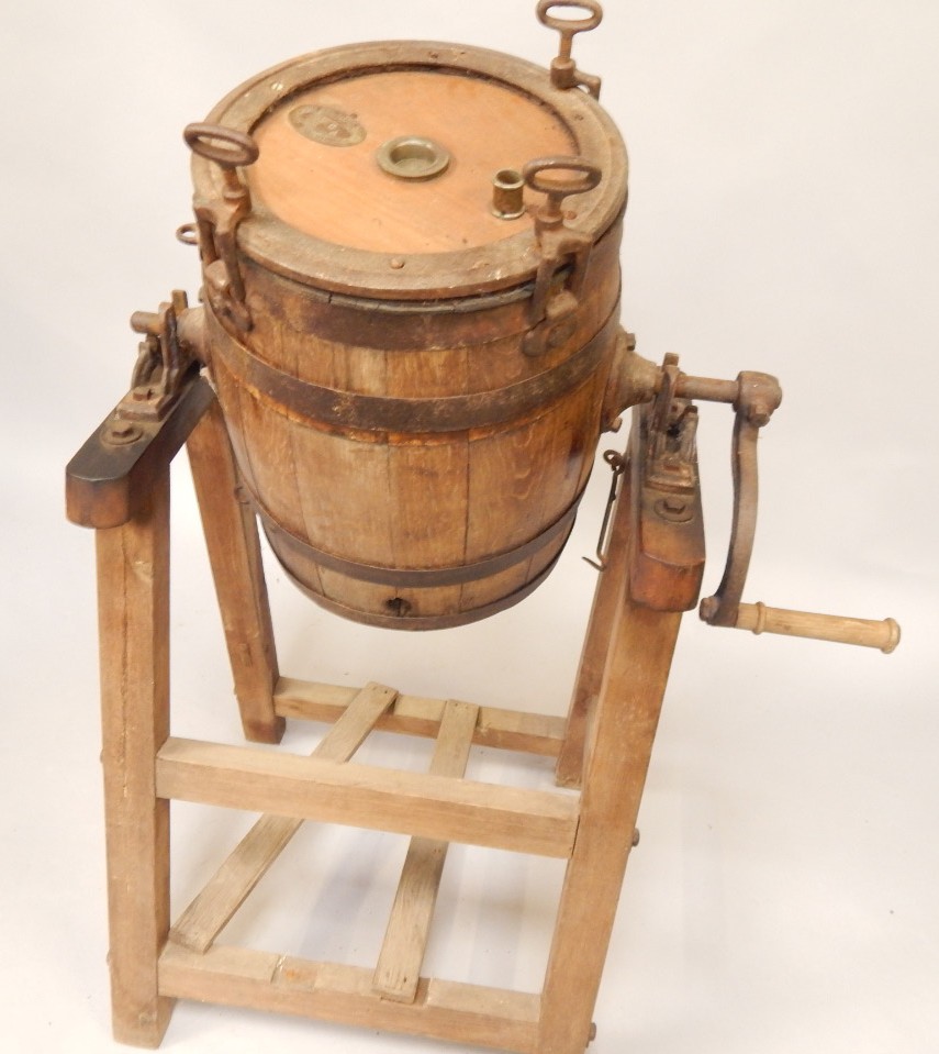 Appraisal: An old oak coopered butter churn on stand by The